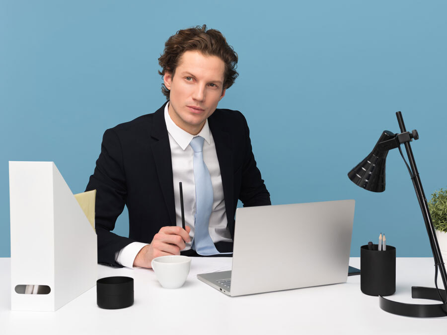 Ein Mann mit unsicherem Gesichtsausdruck sitzt Rechner. Er kann nicht Nein sagen.